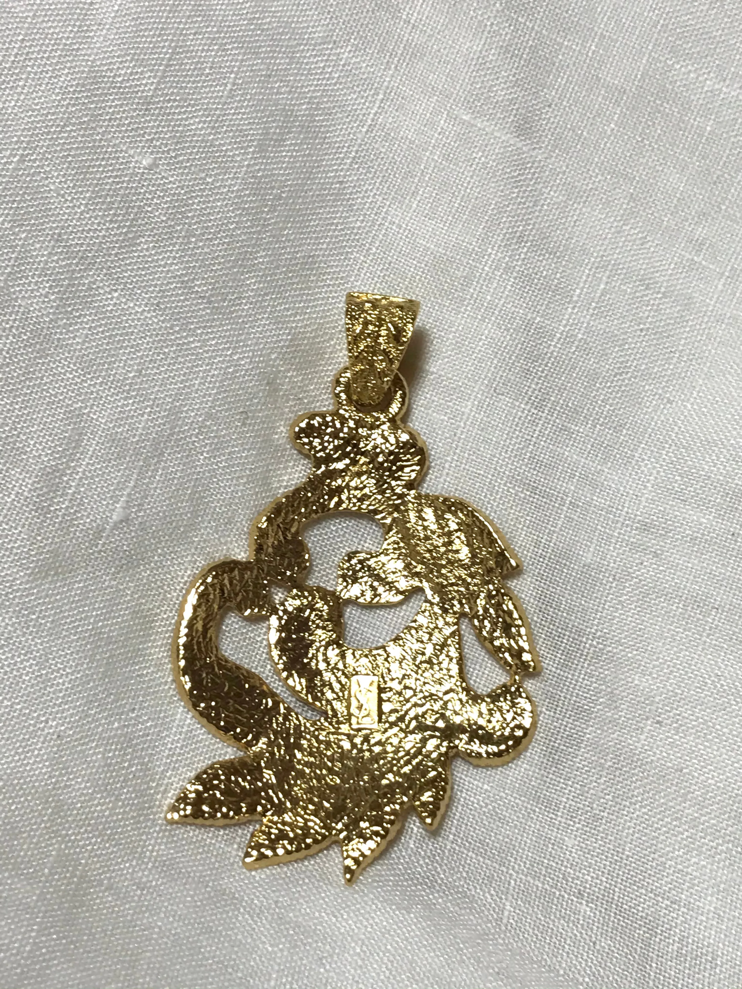 MINT. Vintage Yves Saint Laurent golden arabesque design pendant top. YSL leaf design top. Enjoy it with your own necklace. 061105re4