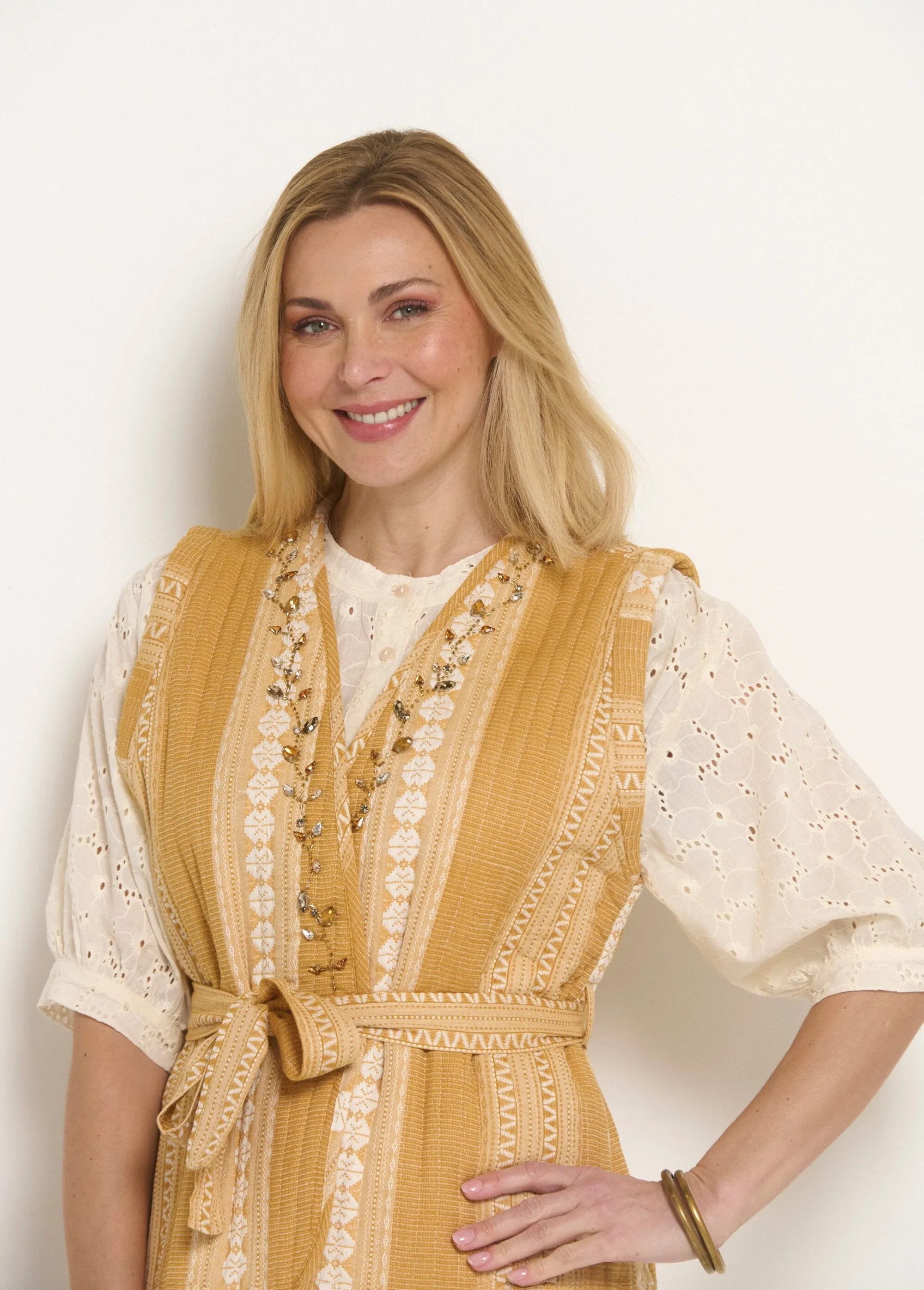 Sleeveless quilted jacket with rhinestone details