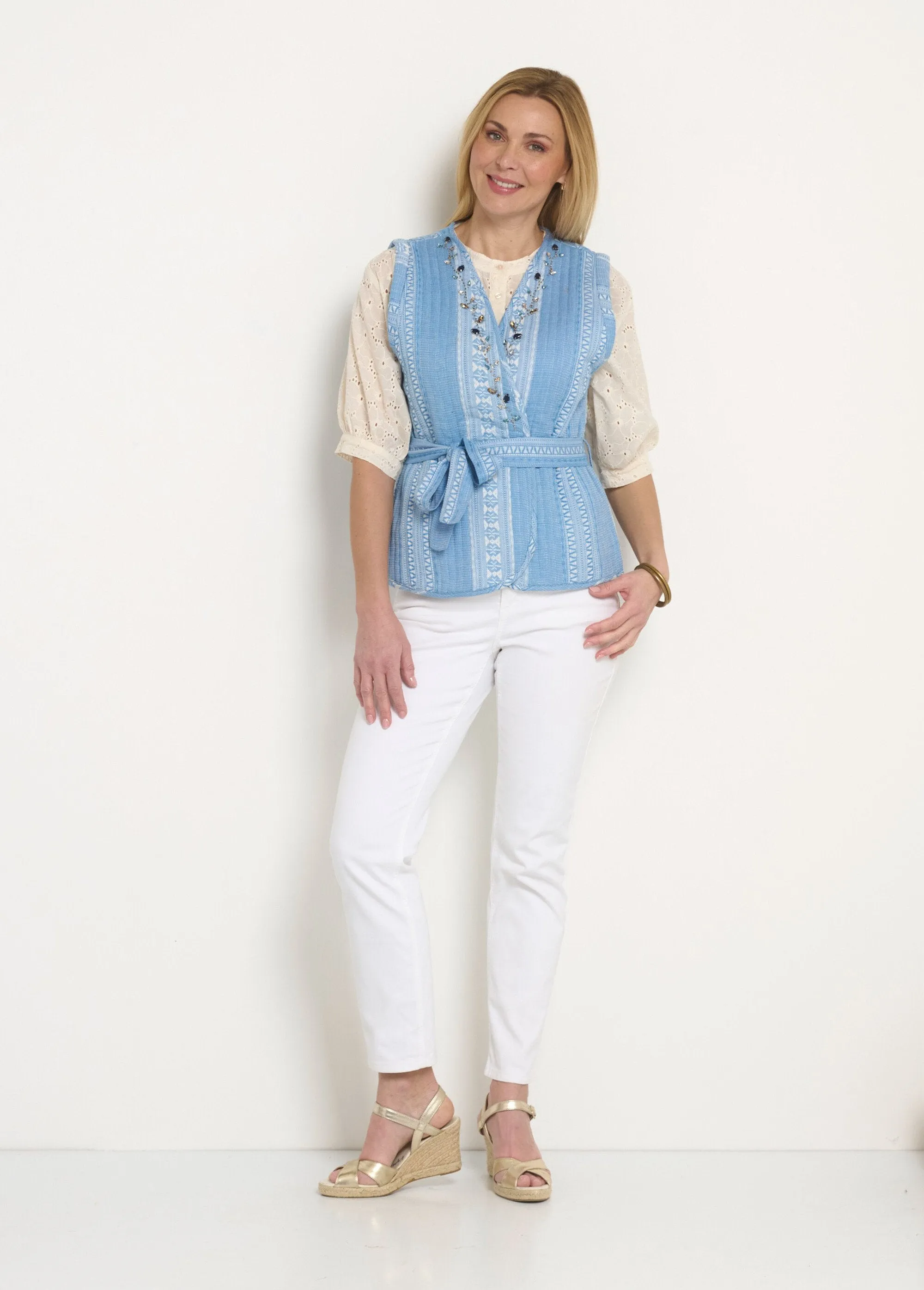 Sleeveless quilted jacket with rhinestone details